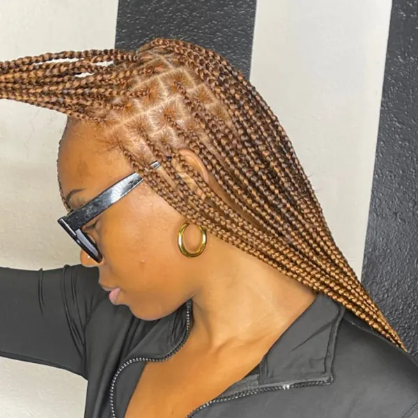 Hair work by Braids By Us